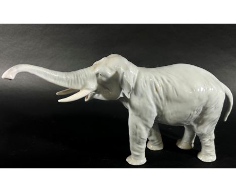 Three Royal Copenhagen porcelain figures to include an elephant, a deer and a boy (3) 
