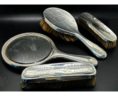 An assortment of six silver backed brushes and a single silver hand mirror (7)