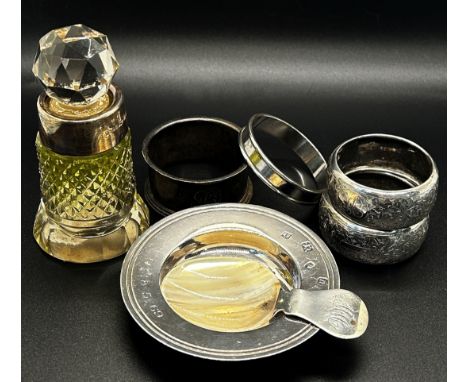 a selection of silver ware including four napkin rings, a small Armada dish, a caddy spoon and a scent bottle with a silver c