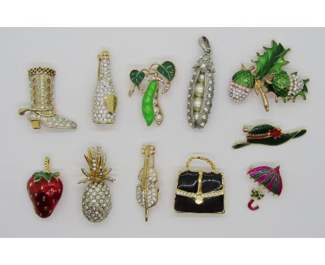 Collection of decorative novelty costume jewellery brooches of various design, to include a bottle of champagne, a strawberry