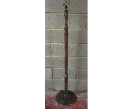 A vintage stained beechwood standard lamp with turned column raised on a stepped disk shaped platform base, 157cm (full heigh