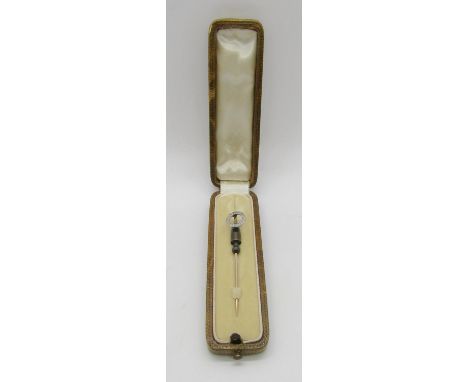 Antique yellow metal stick pin with white metal diamond set hoop head, contained in a period stick pin case 