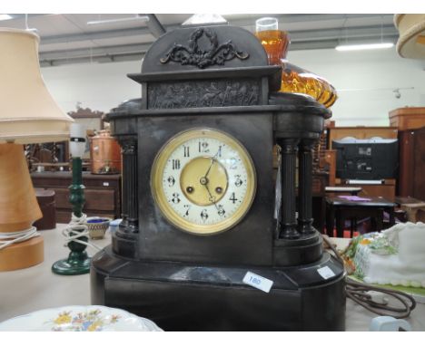 A Victorian black marble/slate mantel clock having classical design with pillar supports and striking movement