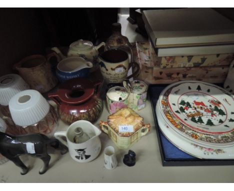 A shelf of ceramics including Masons Christmas Village plates, mottoware jug etc