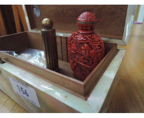 A mother of pearl box containing vintage perfume bottle by Lentheric and Oriental red covered