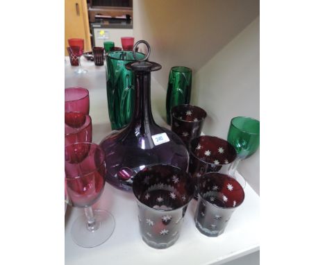 A selection of coloured glassware including Bohemian, art glass and onion shape decanter