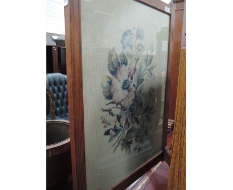 An early 20th Century oak firescreen