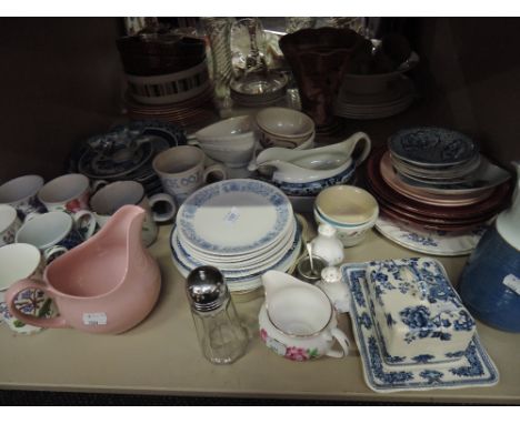 A shelf of ceramics including Masons and Royal Doulton etc