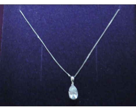 A white metal crystal tear drop pendant stamped 9K on a fine white metal chain stamped 9K