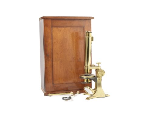 A Baker binocular compound microscope, English, late 19th century,in fitted mahogany case with six objectives, three oculars,