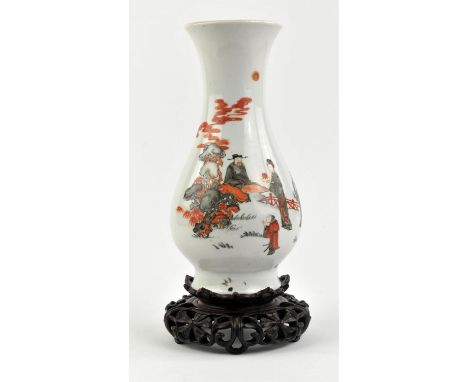 A Chinese vase with trumpet neck, decorated in black and orange with a seated scholar and three other figures in a narrative 