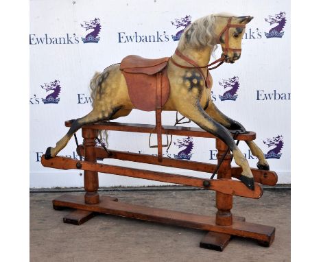 Dapple grey rocking horse, late 19th century, with horse hair main and tail, leather saddle and metal stirrups, on an iron an