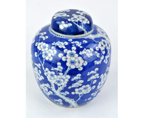 A blue and white prunus jar with domed cover, the base with four-character mark of  Kangxi, but not of the period; a soapston