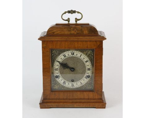 A walnut bracket clock, in the 18th Century style, with silvered Roman numeral chapter ring, with pierced brass spandrels, wi