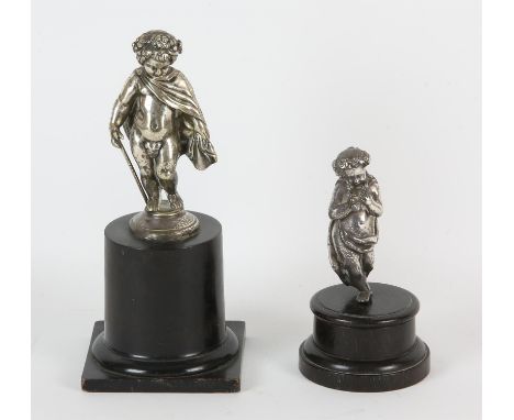 A  silver plate brass figure of a putto, late 19th/early 20th Century, modelled standing wrapped in a cloak, with a walking c