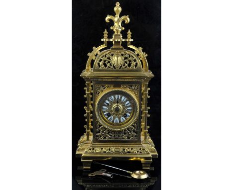French brass mantel clock, late 19th Century, the case of pierced architectural design, the chapter ring with enamelled  with