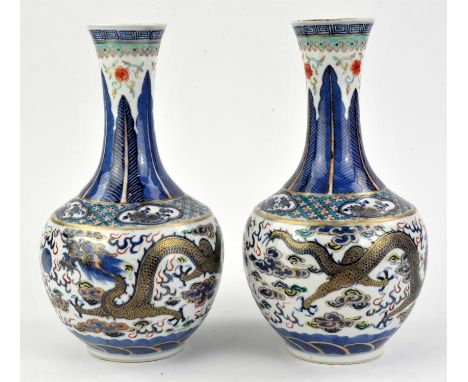 A pair of polychrome vases decorated with dragons, 26 cm high, with four-character marks for Kangxi, but not of the period [2