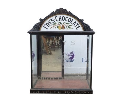 An Fry's chocolate ebonised wood cabinet, with a painted glass cresting, with a plaque to verso reading, R Palmer Maker Jubil