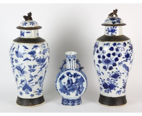 A Chinese blue and white Pilgrim Flask shaped vase, decorated with three seated scholars; the base with Kangxi four-character