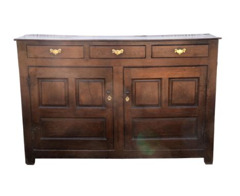 Oak dresser base,19th century, with three frieze draws above panelled doors enclosing shelf, on stile feet, 93cms x 141cms x 