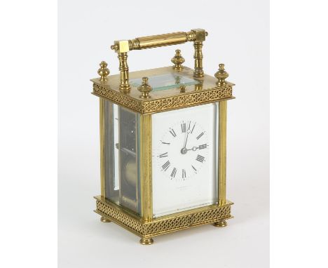 French brass carriage clock, 19th Century, the case with four finials, with grilled decoration in two bands, the white enamel
