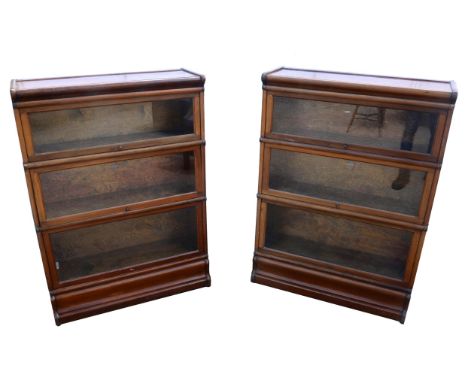 Pair of Globe Wernike bookcases, in three tiers with glazed lifting doors, on plinth bases,with labels to middle sections, 12