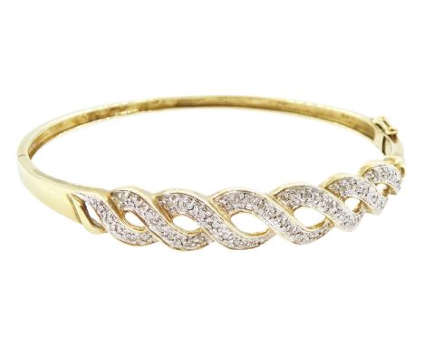 9ct gold diamond chip diamond crossover bangle, Birmingham import mark, total diamond weight approx 0.25 caratCondition Repor