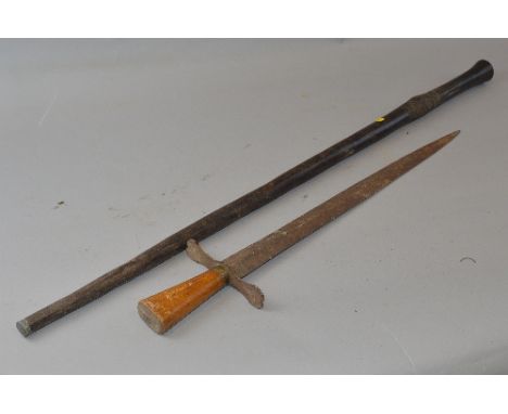 A BLACK COLOURED WOODEN WALKING CANE, possibly African in origin, carved decoration below grip, metal end cap, also a crude, 