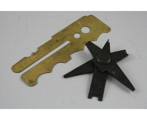 A WWII ERA BUTTON CLEANER PLATE, marked Patent No.116972/17 W.H.B. and a black steel three part weapon tool marked J.W.S.R. S