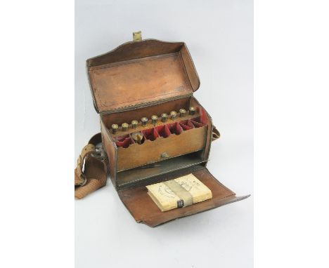 A PRE WWI ERA LEATHER GUN CLEANING TOOL, STORAGE AND AMMUNITION KIT BOX, this example contains spent .303 rifle shells and an