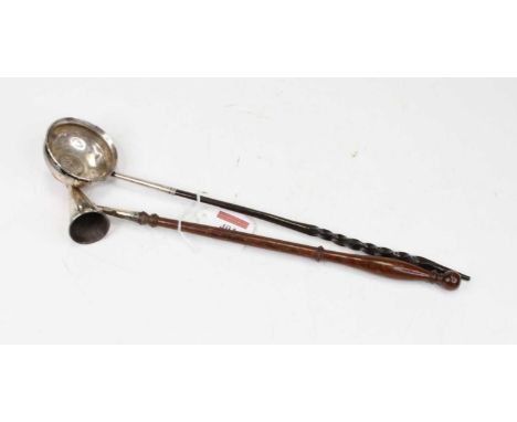 An 18th century white metal toddy ladle, inset with a 1720 silver shilling, on a turned whalebone handle; together with a mod