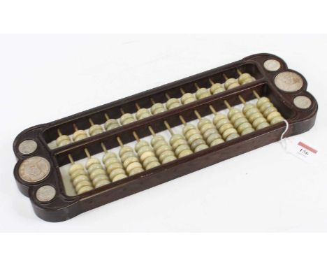 A Chinese carved hardwood and green polished hardstone abacus, 42 x 14cmIntact and useable, some of the beads are cracked.