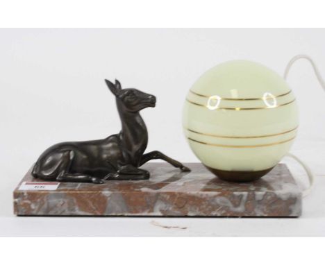 An Art Deco table lamp, the globular glass shade beside a spelter model of a deer, upon a polished hardstone plinth, w.23.5cm