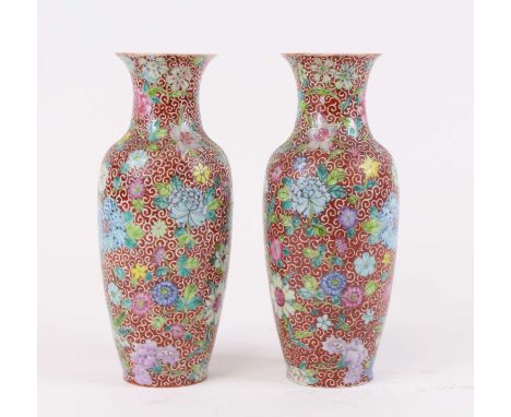 A pair of Chinese porcelain vases, each enamel decorated with flowers, four character seal mark to the underside, each height