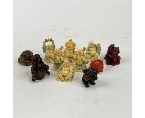 A reproduction Japanese boxwood netsuke in the form of a monkey seated upon a barrel, h.5cm; together with various resin mode