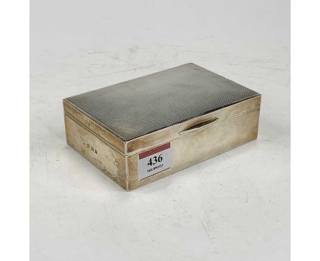 An Elizabeth II silver table cigarette box, of typical rectangular form, having engine turned lid and cedar lined interior 