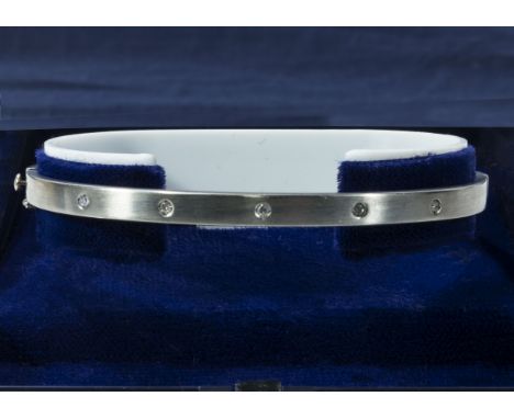 A 9ct yellow and white gold bangle set with diamonds, weight 6gms