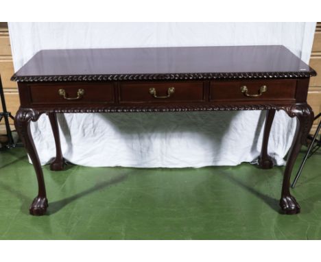 A reproduction mahogany 3 drawer side table in the Chippendale style.