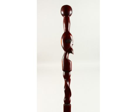 A HEAVY WOOD AFRICAN WALKING STICK with a head. 102cms long.