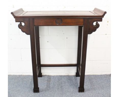 A GOOD TALL CHINESE HARDWOOD ALTAR TABLE, with scroll ends, and a plain frieze with a carved symbol, supported upon four legs