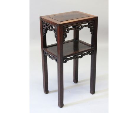 A GOOD 19TH CENTURY CHINESE HARDWOOD TWO TIER STAND,  the top of rectangular form with a lower tier, the apron carved and pie