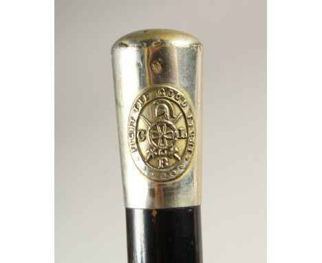 AN EBONISED WALKING STICK, with plated handle "Fight the Good Fight". 91cms long.