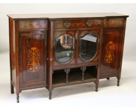 AN EDWARDIAN ROSEWOOD INLAID BREAKFRONT CUPBOARD, the centre with two oval mirrored doors with shelf below, flanked by panel 