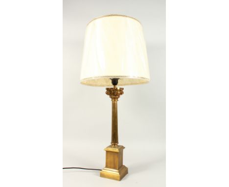 A CORINTHIAN COLUMN BRASS CANDLESTICK, converted to a lamp with a shade.