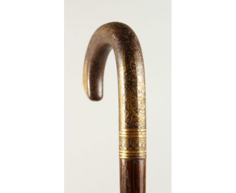 A VERY GOOD WALKING STICK with gold inlaid handle. 98cms long.