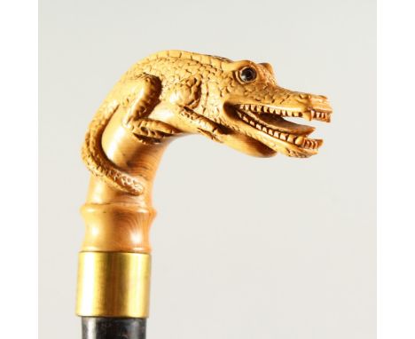 A GOOD EDWARDIAN WALKING STICK with carved alligator handle. 85cms long.