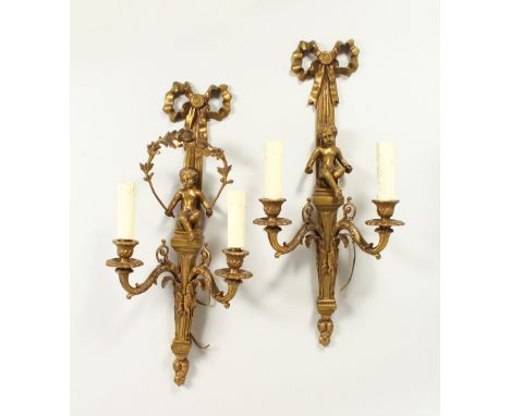 A PAIR OF FRENCH BRASS TWO-LIGHT WALL SCONCES, with cupids and ribbon motifs. 47cms long.
