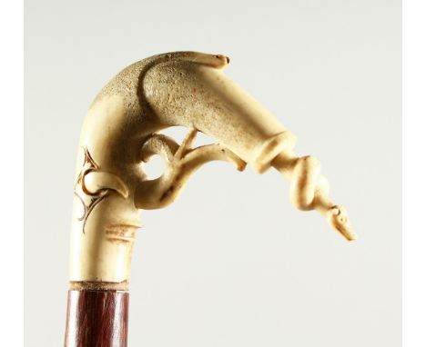 AN EDWARDIAN WALKING STICK, with very unusual carved bone handle, after DALI.