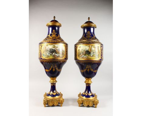 A SUPERB PAIR OF LARGE SEVRES VASES AND COVERS, with rich ormolu mounts and pineapple finials, the body painted with two larg