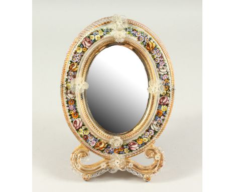 A 19TH CENTURY VENETIAN OVAL EASEL MIRROR, with enamel mosaic flowers. 32cms high.